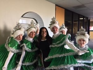 KTVU's Gasia Mikaelian with - Are those the Tap-Dancing Christmas Trees with her?