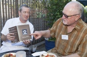 Owner Pat Feehan sharing new catering menu with Mayor Kurt Brinkman